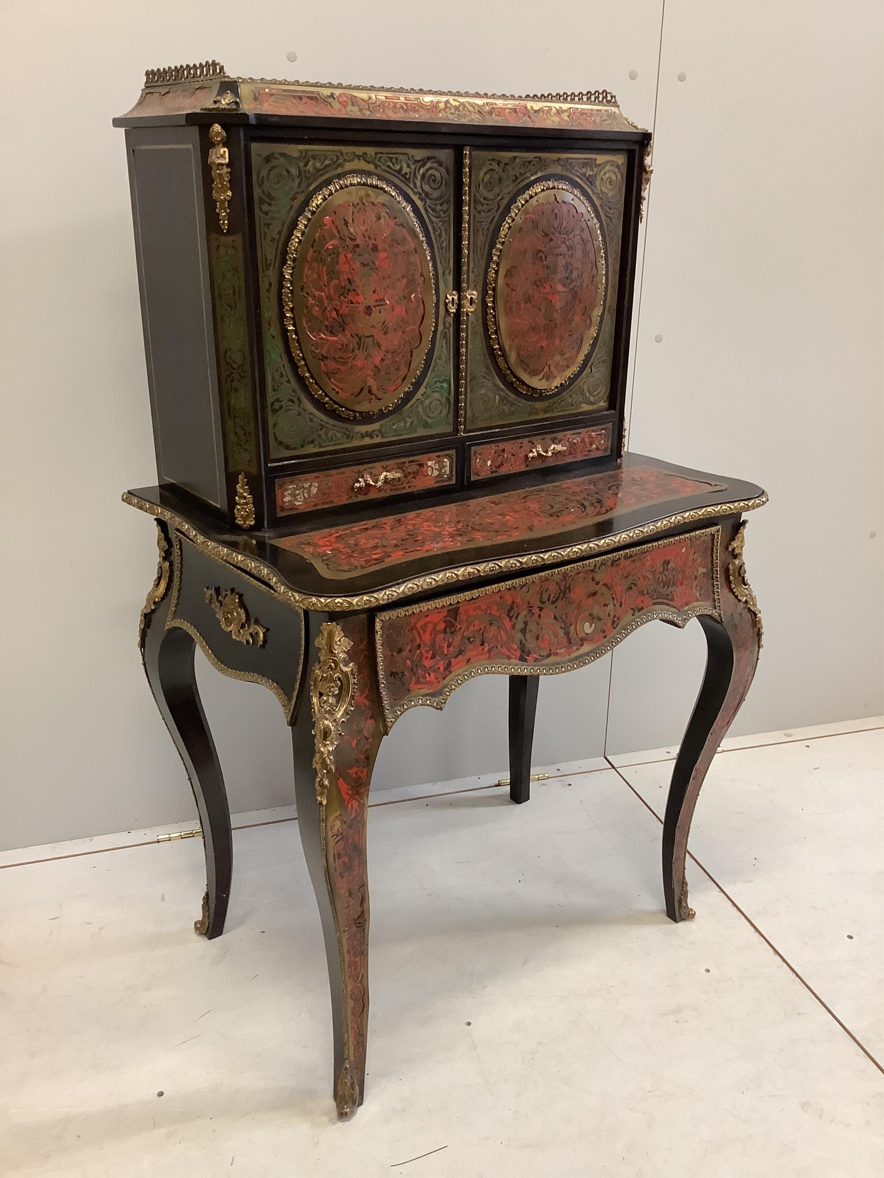 A 19th century French ebonized Boulle bonheur du jour, width 78cm, depth 54cm, height 128cm. Condition - fair to good, some minor losses and raised cut brass work.